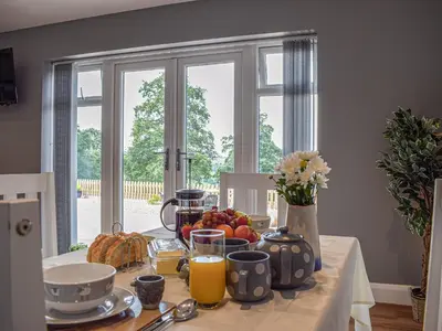 a table with fruit and juice on it with a window at The Lookout - Uk35022 in Hope under Dinmore