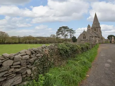 an old stone wall in front of a church at Y Bwthyn in Llanrhystyd