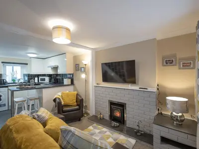 a living room with a couch and a fireplace at Y Bwthyn in Llanrhystyd