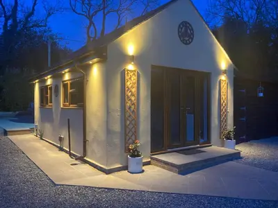 a small house with lights on the front of it at Mini haven in Oswestry