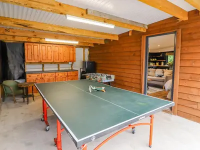 a ping pong table in a room at The Cabin at Evelyns Retreat in Corwen
