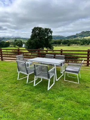 a white picnic table and chairs in the grass at Cwmgwn Farm in Llandovery