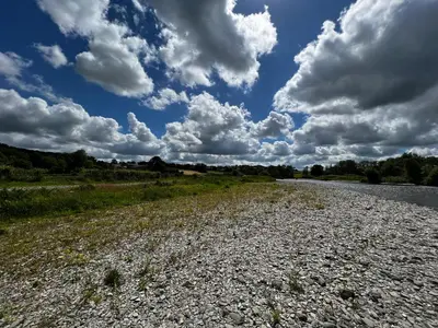 a gravel road with a sky with clouds at Cwmgwn Farm in Llandovery