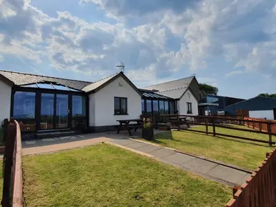 a house with a picnic table in a yard at The Calf Suite in Aberystwyth