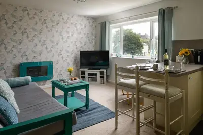 a living room with a couch and a table at Finest Retreats - Golygfa o'r Castell - Castle Views in Harlech