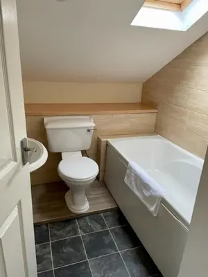 a small bathroom with a toilet and a bath tub at Apartment 14 in Aberystwyth