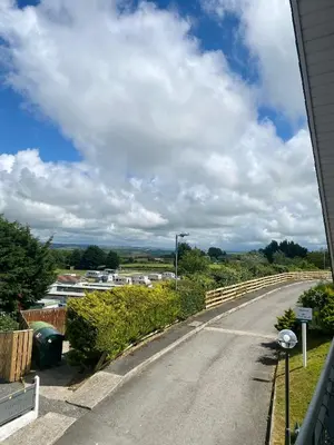 an empty road with a cloudy sky in the background at Apartment 14 in Aberystwyth