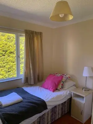 a bedroom with a bed with a window and a bed sidx sidx sidx at Lodges at Bryncarnedd, Aberystwyth in Aberystwyth