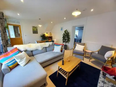 a living room with a couch and a table at 2 Bed in Aberaeron oc-bow329 in Aberaeron