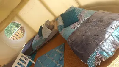 a group of pillows sitting on the floor in a room at Yurt Uchaf Off-Grid Glamping in Machynlleth