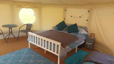 a bedroom with a bed in a tent at Yurt Uchaf Off-Grid Glamping in Machynlleth