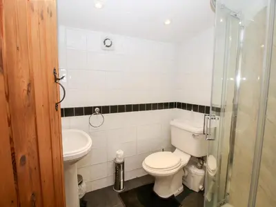 a bathroom with a toilet and a sink at The Retreat in Oswestry