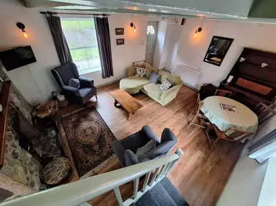 an overhead view of a living room with a couch and chairs at Cosy riverside cottage in beautiful Corris in Corris
