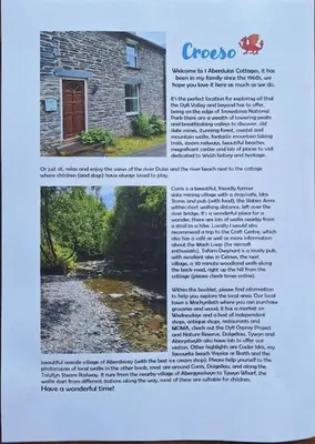 a page of a magazine with a picture of a house at Cosy riverside cottage in beautiful Corris in Corris