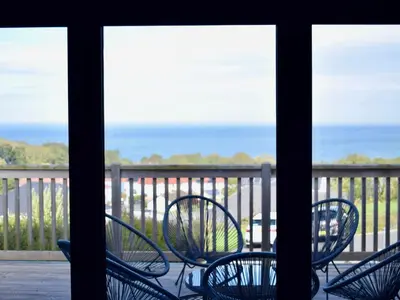 a group of chairs sitting on a porch at Ty Ni in New Quay