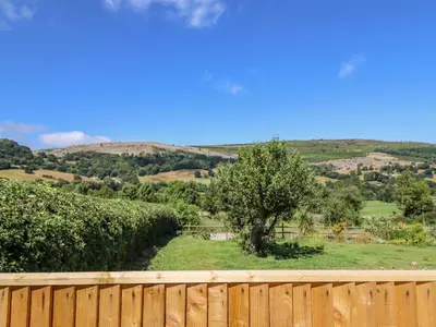 a wooden fence with a view of a tree at Cam O'r Fechan Annexe in Llangollen