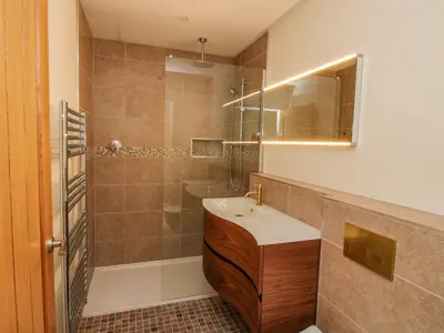 a bathroom with a sink and a shower at Llety Cariad in Montgomery