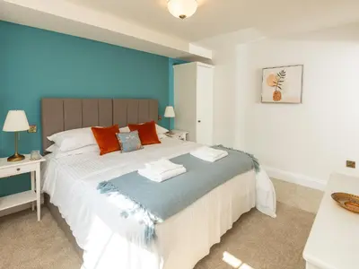 a bedroom with a large bed with blue walls at Old Rectory House in Newtown