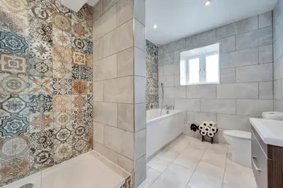 a bathroom with a tub and a toilet and a sink at 4 Bed in Aberystwyth oc-bow304 in Rhostie
