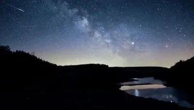 a starry night with the milky way over a pond at Forester's Retreat Glamping - Dinas View - Vaccinated dogs over the age of 2 are accepted in Aberystwyth