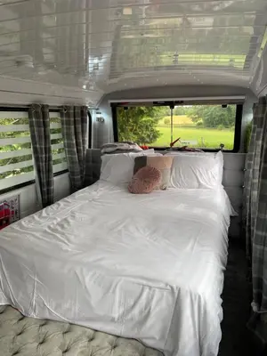 a large white bed in the back of an rv at Double Decker Bus in Aberystwyth