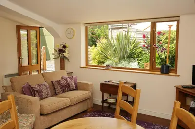 a living room with a couch and a table at Great Western Lodge at Eaton Manor in Eaton