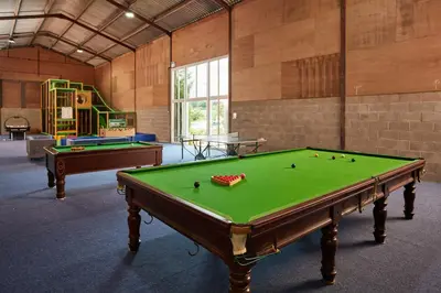 a large room with a pool table and a playground at Great Western Lodge at Eaton Manor in Eaton