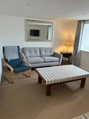 a living room with a couch and a chair at Harbour Apartment in Barmouth