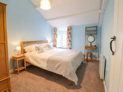 a bedroom with a bed and a window at Preswylfa in Blaenau-Ffestiniog
