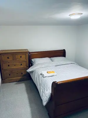 a bedroom with a bed and a wooden dresser at 21 ,North Street in Shrewsbury