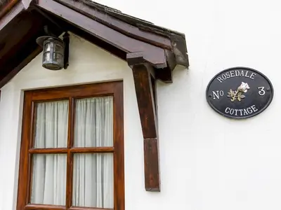 a sign on the side of a building with a window at Cosy cottage with views over the Shropshire hills - Pass the Keys in Ludlow