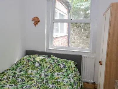 a bedroom with a bed and a window at 4 Tanyrallt Terrace in Llangollen