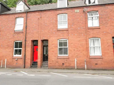 a red brick building with a red door at 4 Tanyrallt Terrace in Llangollen