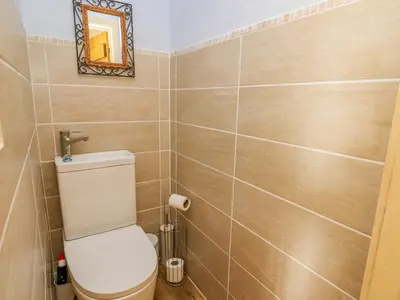 a bathroom with a toilet and a mirror at Buzzards Breg in Builth Wells