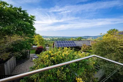 a view from the balcony of a house with solar panels at Hay Barn, Penrheol Farm, Unique Barn Conversion in Builth Wells