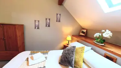 a bedroom with a white bed and some pictures on the wall at Cader Mountain View Cottage with Hot Tub in Snowdonia in Dolgellau