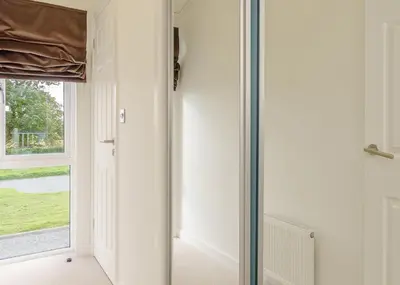 a glass door in a room with a window at Winston Farm Lodges in Ternhill