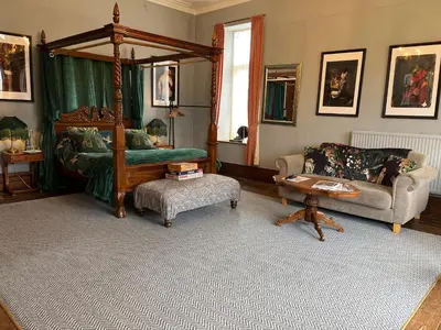 a living room with a canopy bed and a couch at Cader en suite at Pen Y Coed Hall exclusive Luxury Hot Tub in Dolgellau