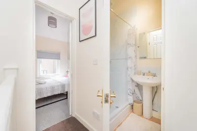 a white bathroom with a sink and a toilet at Coton Hill Shrewsbury Cottage in Shrewsbury