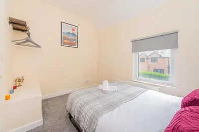 a bedroom with a bed and a window at Coton Hill Shrewsbury Cottage in Shrewsbury