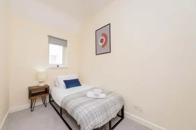 a small bedroom with a bed with a stuffed animal on it at Coton Hill Shrewsbury Cottage in Shrewsbury