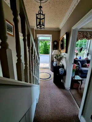 a hallway of a home with a staircase and a living room at YR HEN FICERDY in Aberystwyth