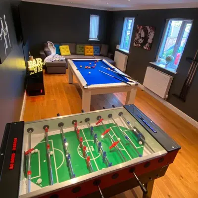 a play room with a pool table in the middle at Luxury 4-5 Bed Home with Games Room and Balcony in Newtown