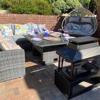 a patio with a couch and a table and a grill at Luxury 4-5 Bed Home with Games Room and Balcony in Newtown