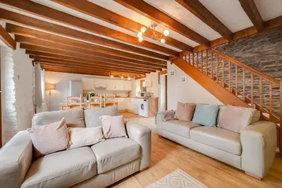 a living room with two couches and a staircase at 3 Bed in Aberaeron oc-bow315 in Cross Inn