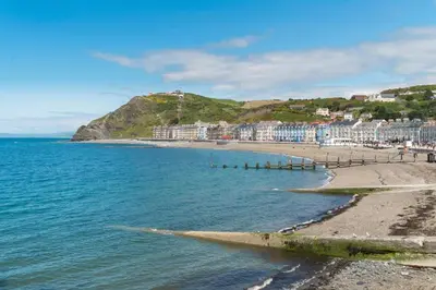 a view of a beach with buildings and the ocean at 3 Bed in Aberaeron oc-bow315 in Cross Inn