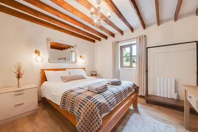 a bedroom with a bed and a dresser and a window at 3 Bed in Aberaeron oc-bow315 in Cross Inn