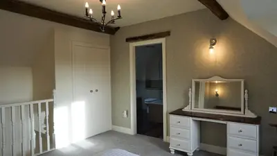 a room with a bathroom with a sink and a mirror at Barley Cottage - 5* Cyfie Farm with log burner and private covered hot tub in Llanfyllin