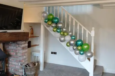 a bunch of balloons are on the stairs at Barley Cottage - 5* Cyfie Farm with log burner and private covered hot tub in Llanfyllin