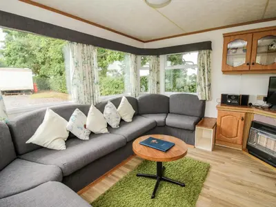 a living room with a couch and a table at 6 Old Orchard in Much Wenlock